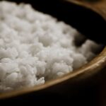 Close-up of freshly cooked white rice in a wooden bowl